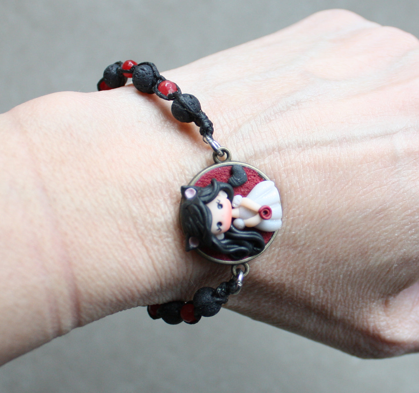 Bracelet with natural stones and pet doll charm.
