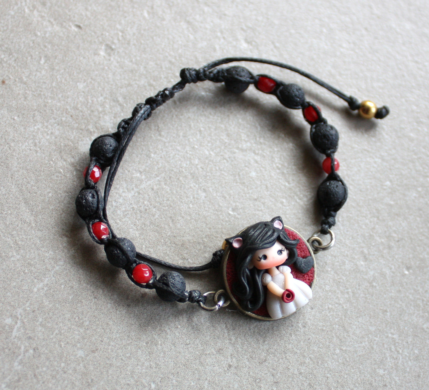 Bracelet with natural stones and pet doll charm.