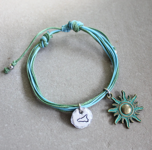 bracciale cordino azzurro con sicilia incisa e sole