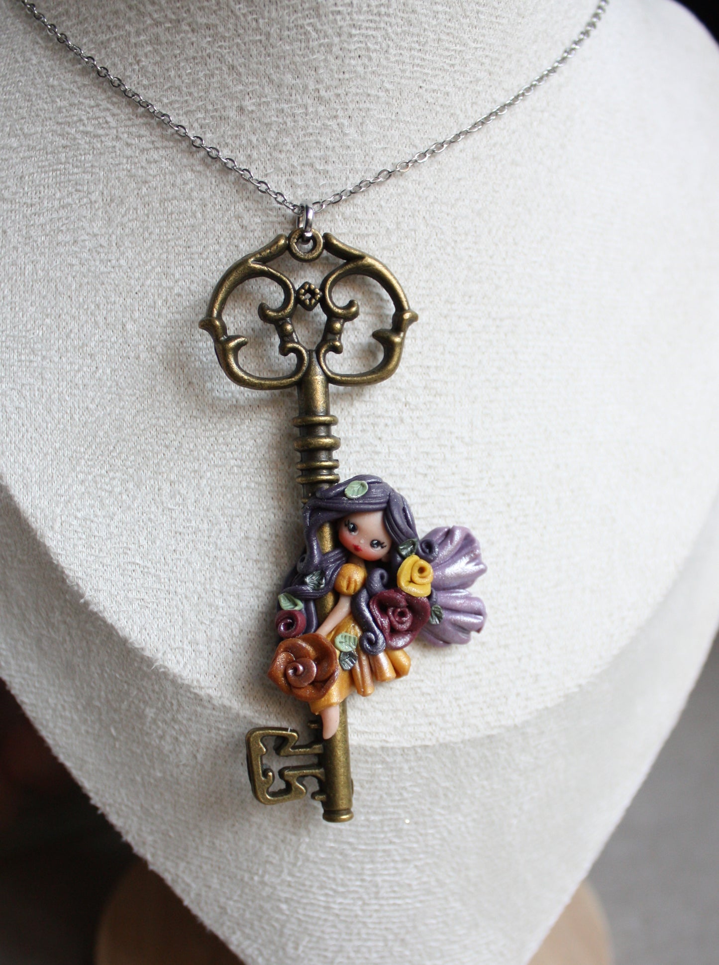 Collana in acciaio inox con chiave bronzata e fatina in fimo II