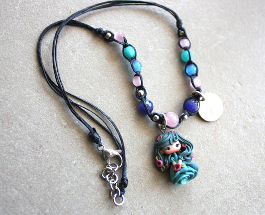 necklace with blu doll