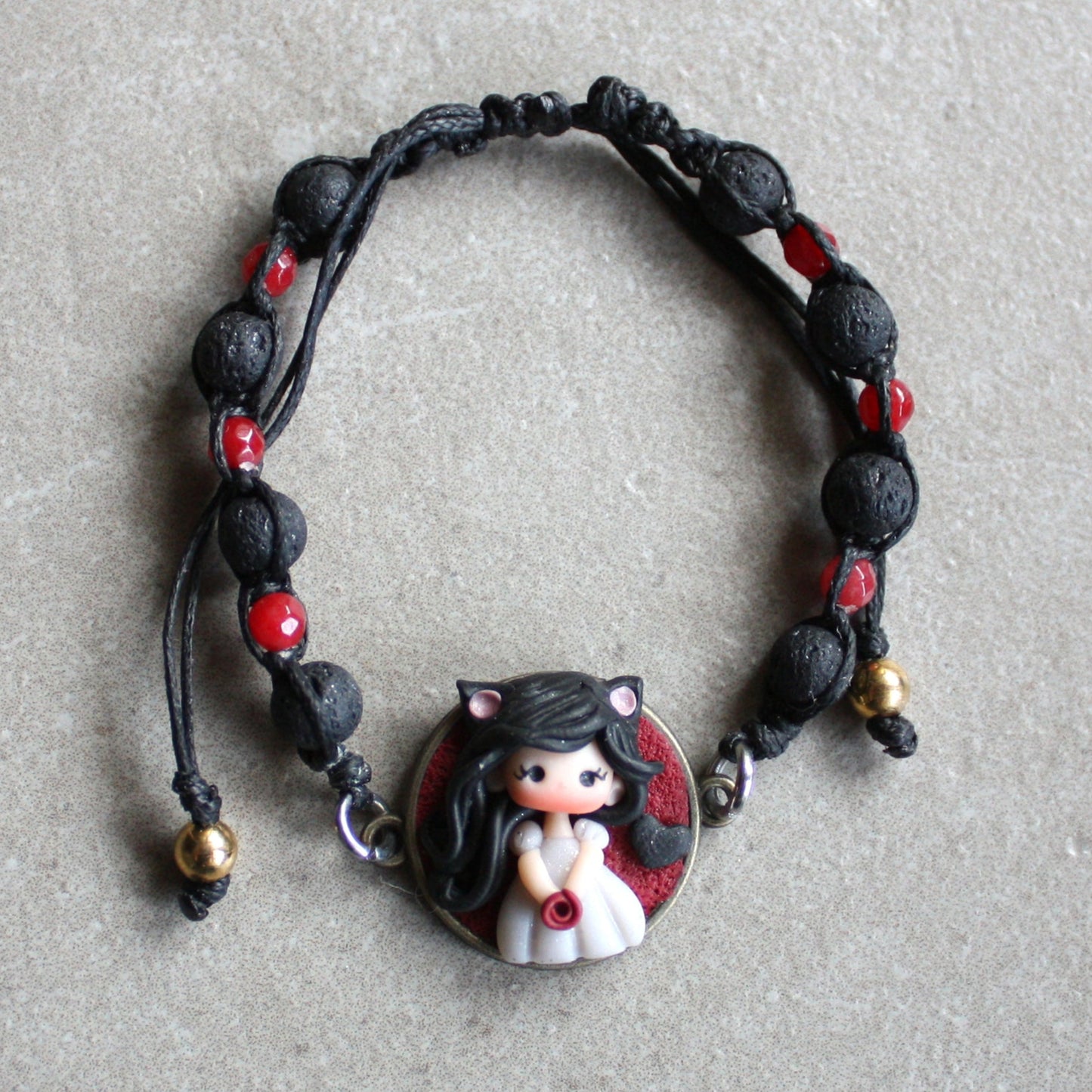 Bracelet with natural stones and pet doll charm.