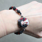 Bracelet with natural stones and pet doll charm.