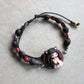 Bracelet with natural stones and pet doll charm.