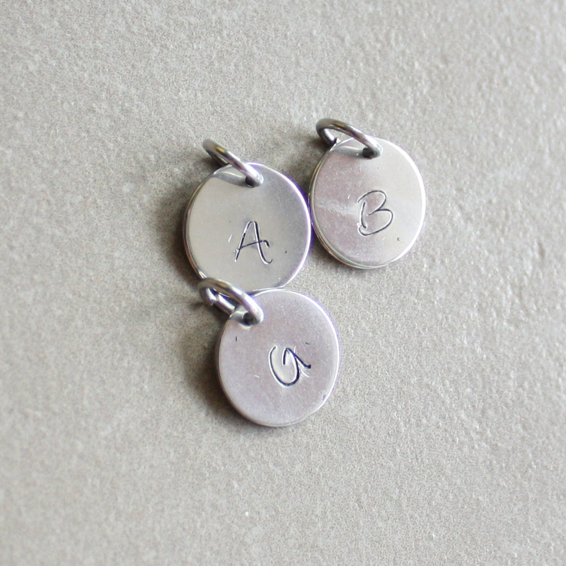 Charm with letter