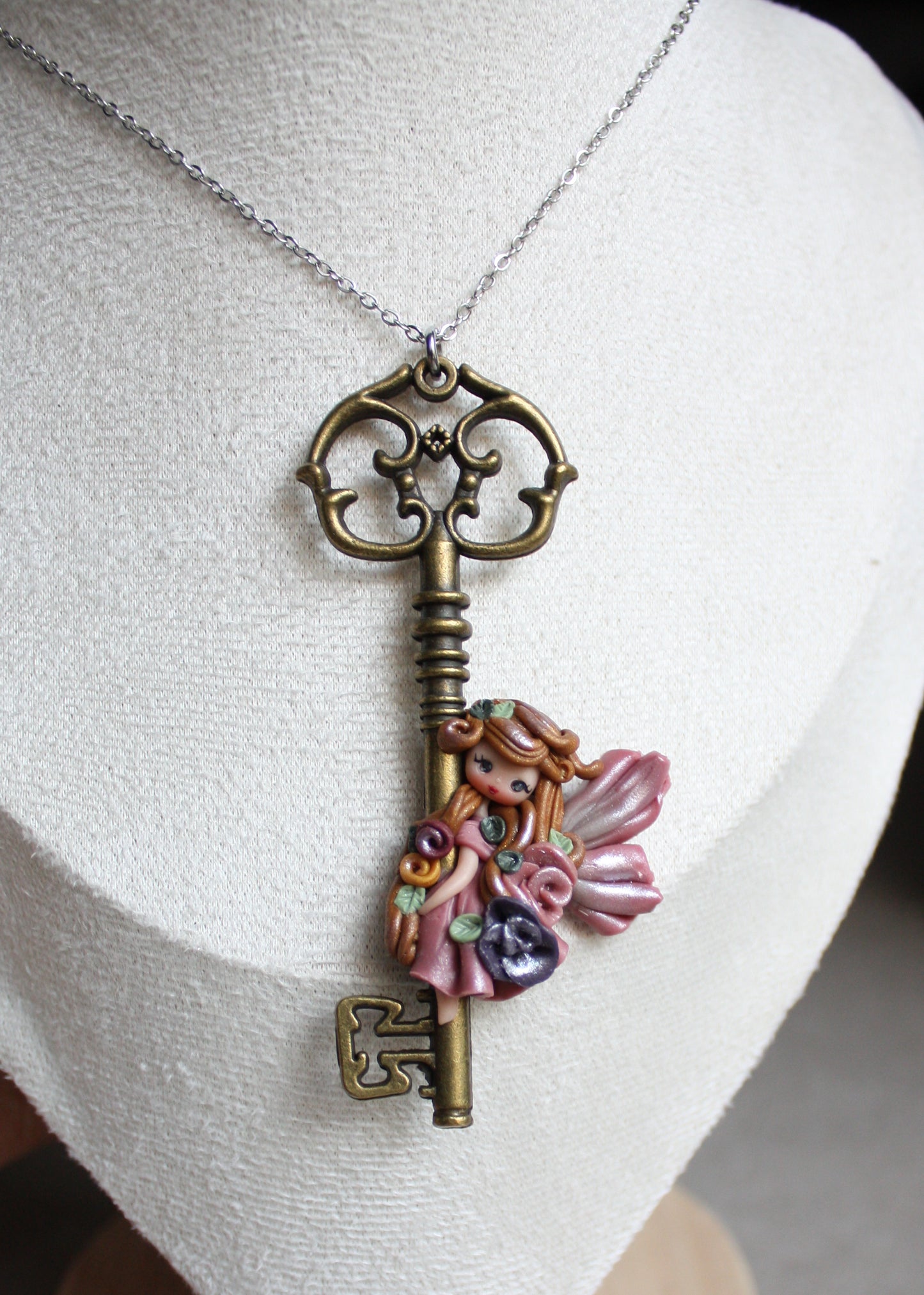 Collana in acciaio inox con chiave bronzata e fatina in fimo