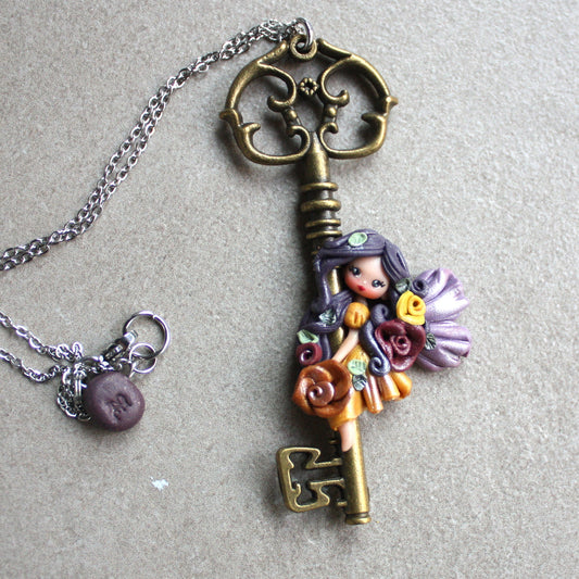 Collana in acciaio inox con chiave bronzata e fatina in fimo II