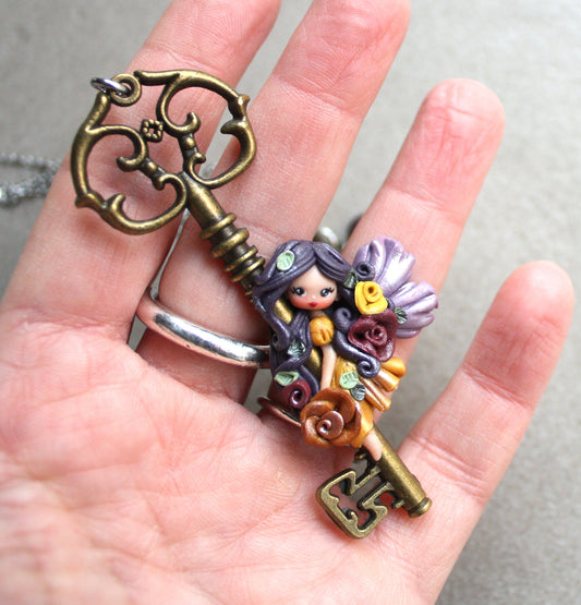 Collana in acciaio inox con chiave bronzata e fatina in fimo II