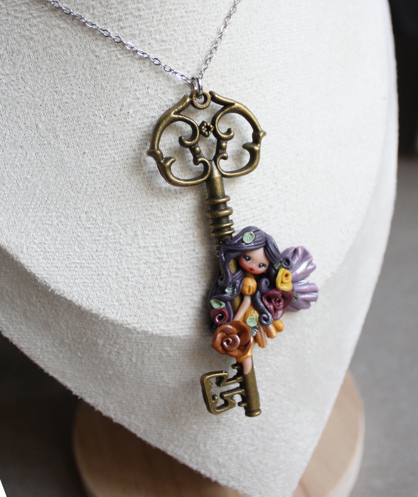 Collana in acciaio inox con chiave bronzata e fatina in fimo II